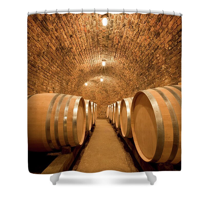 Aging Process Shower Curtain featuring the photograph Wine Cellar With Large Barrels by Benedek