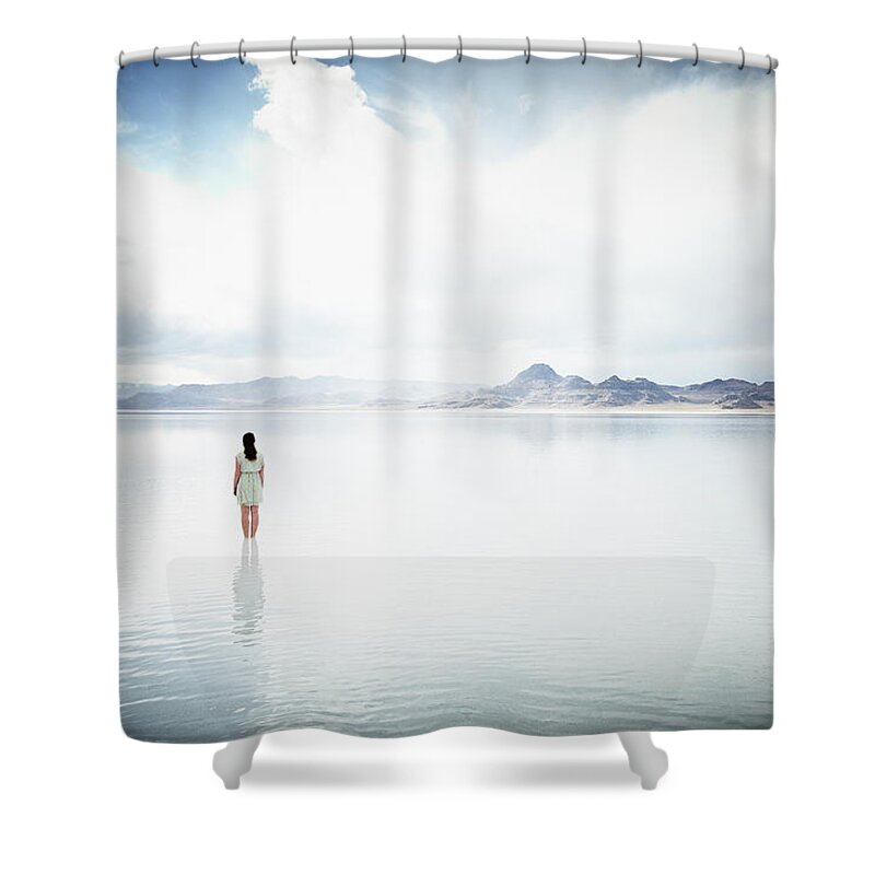 Tranquility Shower Curtain featuring the photograph Woman Standing In Shallow Water Looking by Thomas Barwick