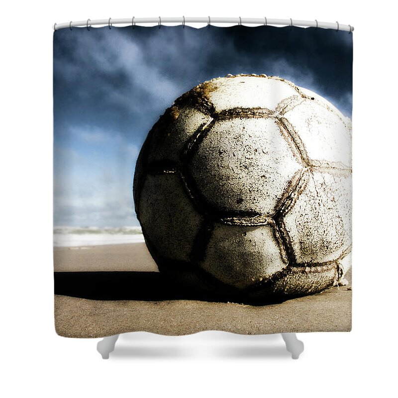 Shadow Shower Curtain featuring the photograph Worn And Old Soccer Ball On Sand by Vithib
