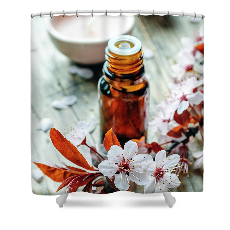 Spa Shower Curtain featuring the photograph Essential massage oil with flower on rustic wooden background. N by Jelena Jovanovic