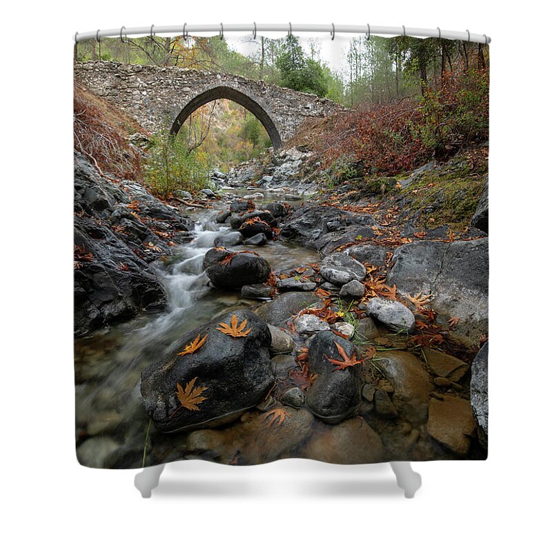 Autumn Shower Curtain featuring the photograph Medieval stoned bridge with water flowing in the river in autumn. by Michalakis Ppalis