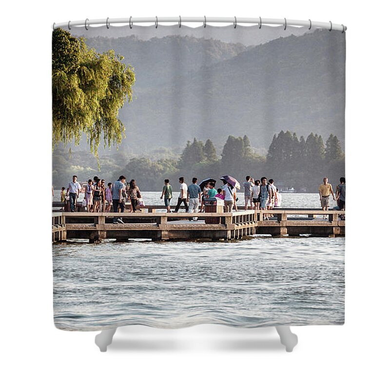 2013 Shower Curtain featuring the photograph People strolling at the edge of the West Lake by Benoit Bruchez