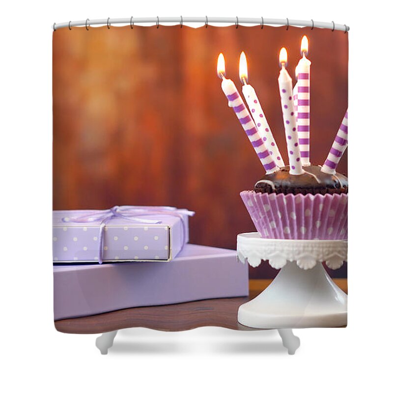 Cupcake Shower Curtain featuring the photograph Purple theme birthday cupcake with candles and gift by Milleflore Images