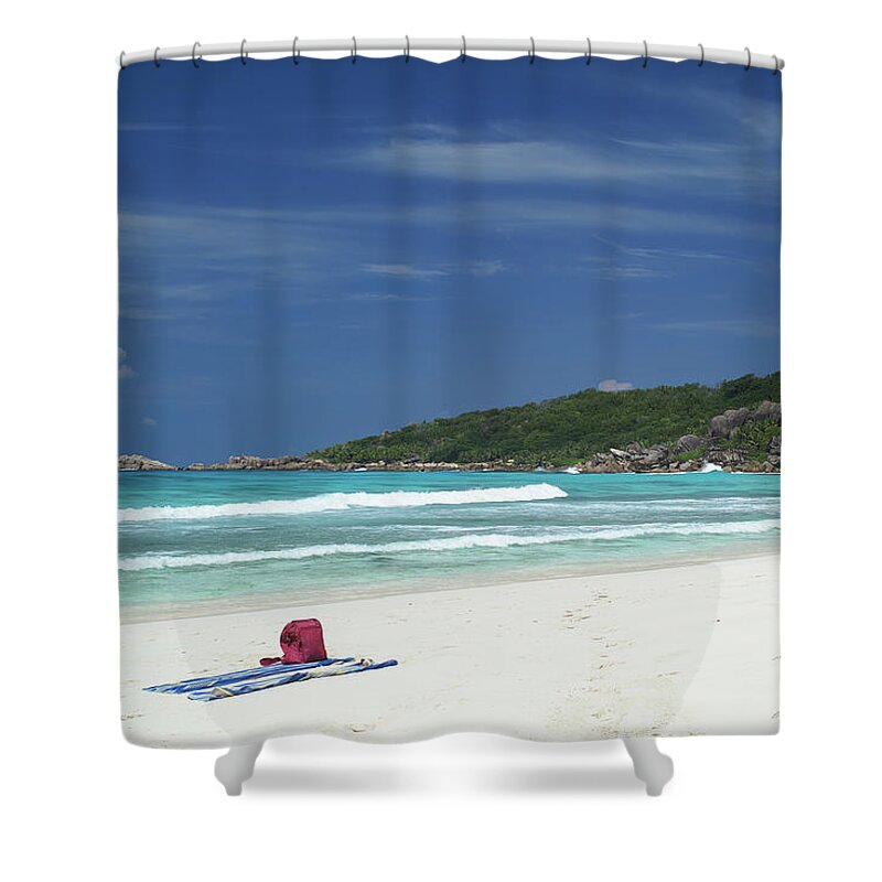 Anse Shower Curtain featuring the photograph Red bag on a white beach in La Digue, Seychelles Islands by Jean-Luc Farges