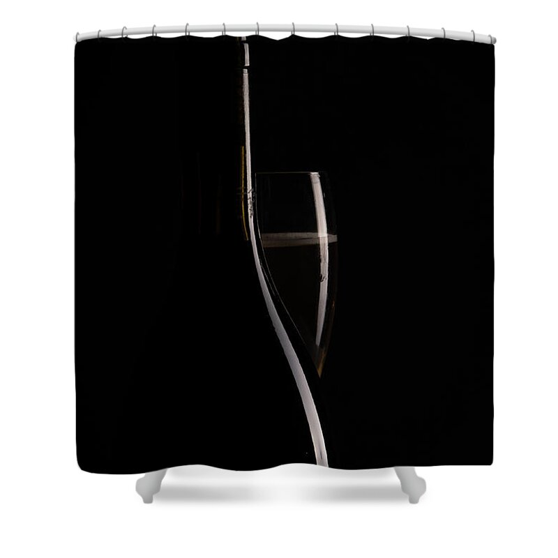 Red Wine Shower Curtain featuring the photograph Red sparking wine on a wineglass and black wine bottle. by Michalakis Ppalis