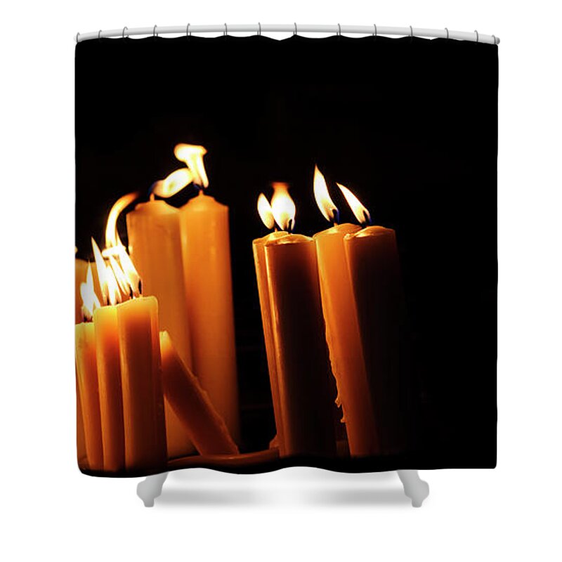 Candle Shower Curtain featuring the photograph Religious candles on black background. Yellow candlelight f by Jelena Jovanovic