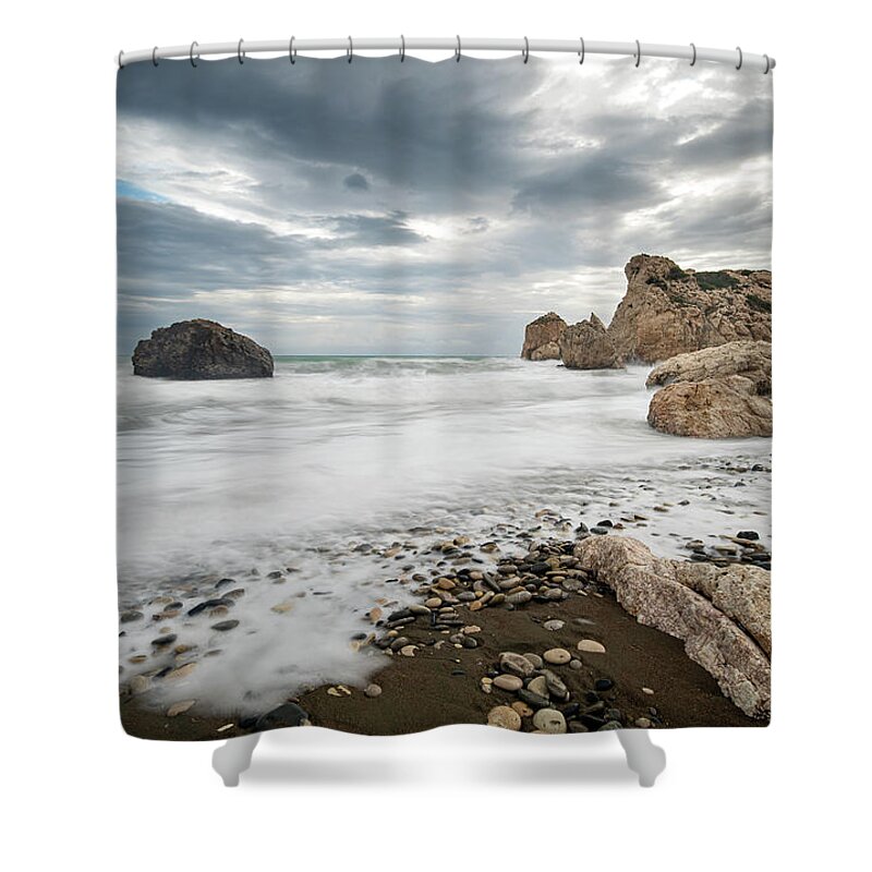Seascape Shower Curtain featuring the photograph Seascape with windy waves splashing at the rocky coastal area. by Michalakis Ppalis