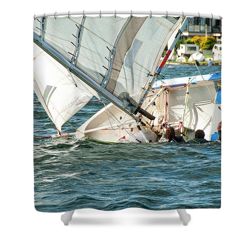 Cloud Shower Curtain featuring the photograph Two children in the water climbing back into a capsized sailboat by Geoff Childs