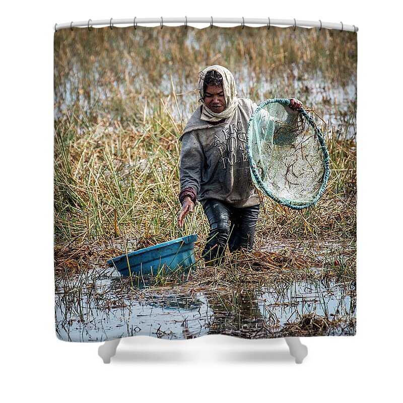 Madagascar Shower Curtain featuring the photograph Woman catching fish in a paddyfield - 2 by Claudio Maioli