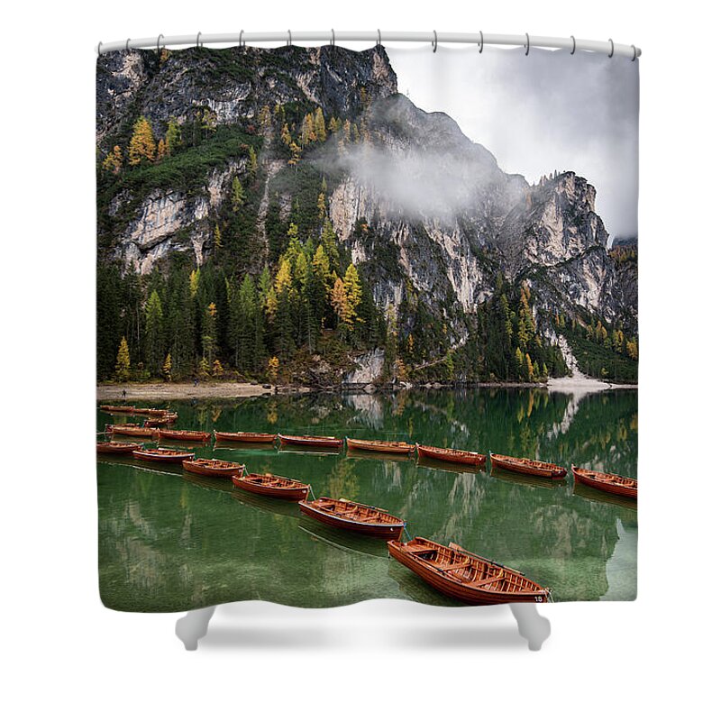 Lago Di Braies Shower Curtain featuring the photograph Wooden boats on the peaceful lake. Lago di braies, Italy by Michalakis Ppalis