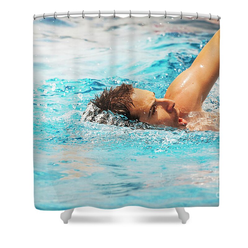 Swimmer Shower Curtain featuring the photograph Young man swimmer train in swimming pool. by Jelena Jovanovic