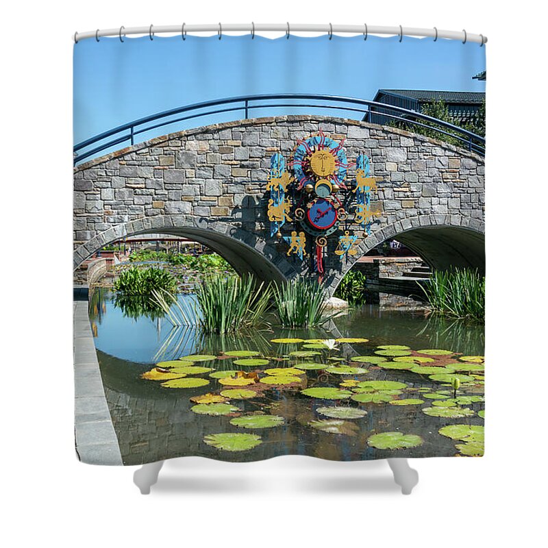 Carroll Creek Shower Curtain featuring the photograph Zodiac inspired clock on a stone bridge in Carroll Creek Park in Frederick Maryland by William Kuta
