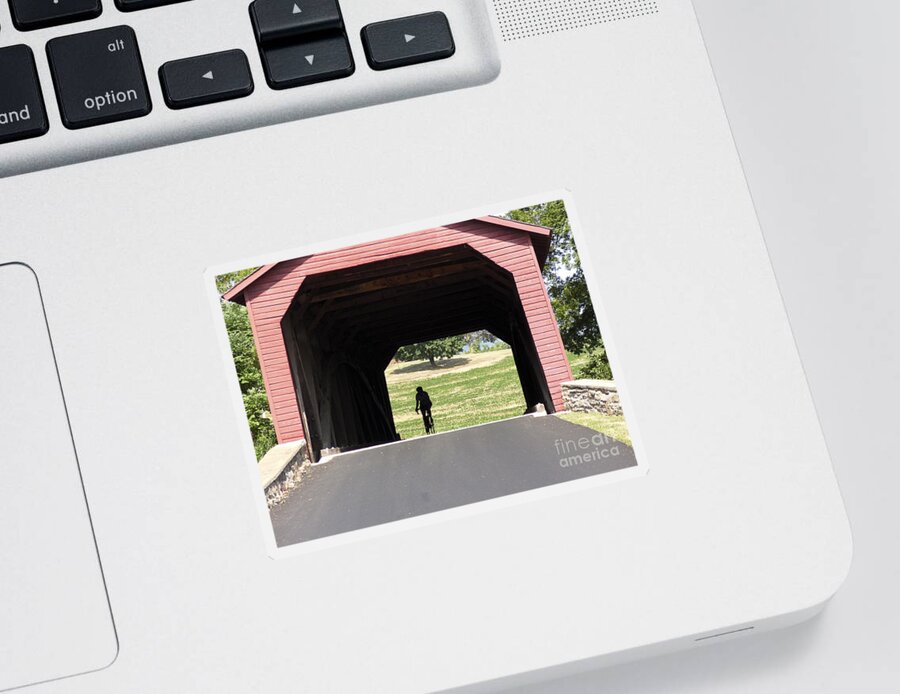 Arch Truss Sticker featuring the photograph Cycling through the Utica Mills Covered Bridge in Maryland by William Kuta