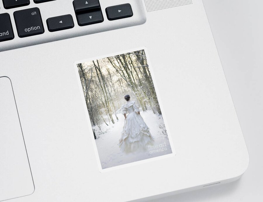Woman Sticker featuring the photograph Victorian Woman Running Through A Winter Woodland With Fallen Sn by Lee Avison