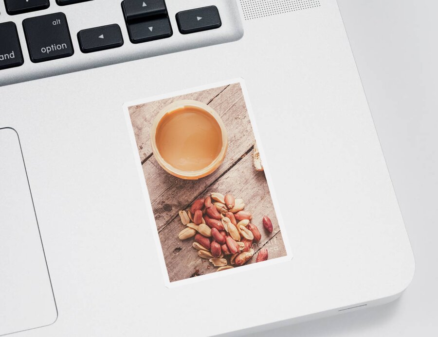 Peanuts Sticker featuring the photograph Peanut butter jar with peanuts on wooden surface by Jorgo Photography