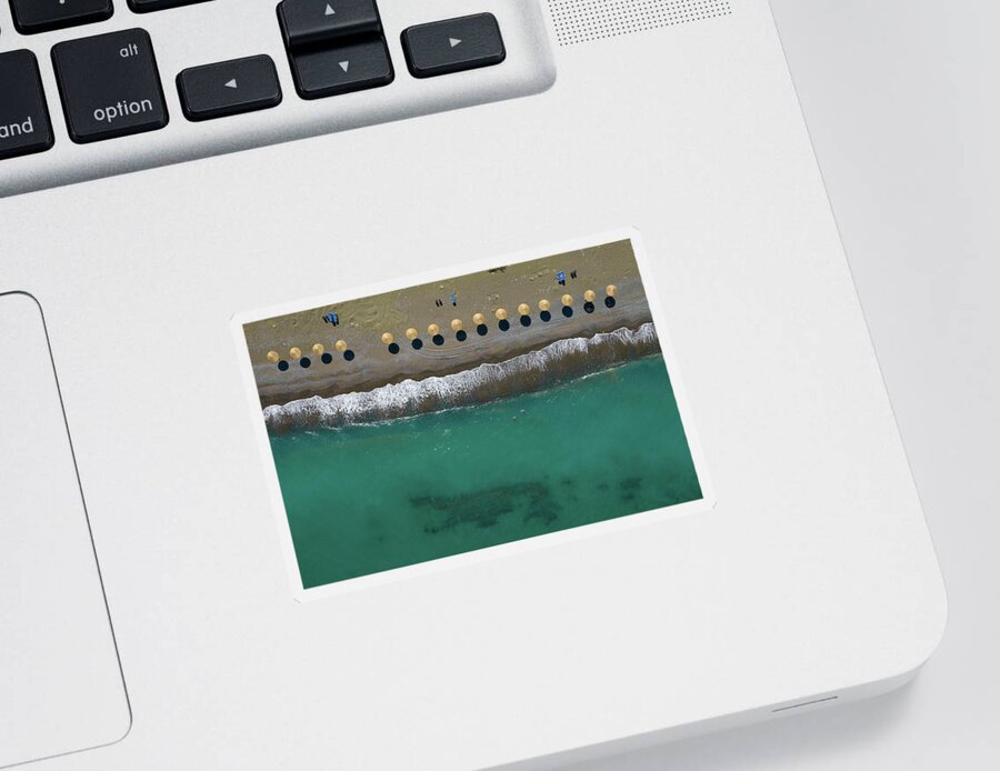  Beach Sticker featuring the photograph Aerial view from a flying drone of beach umbrellas in a row on a by Michalakis Ppalis