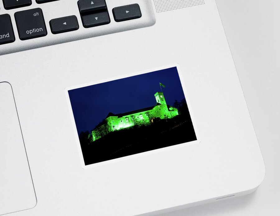 Ljubljana Sticker featuring the photograph Ljubljana Castle lit up green at night to celebrate its status a by Ian Middleton