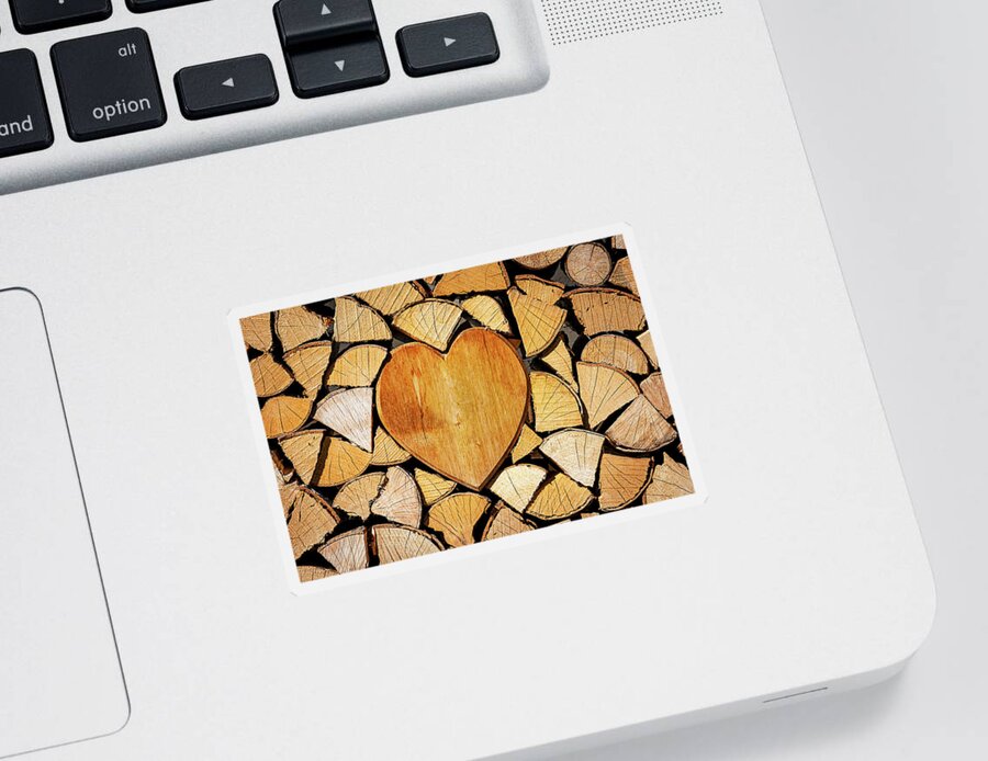 Pile Sticker featuring the photograph Stack of firewood with a wooden heart by Bernhard Schaffer