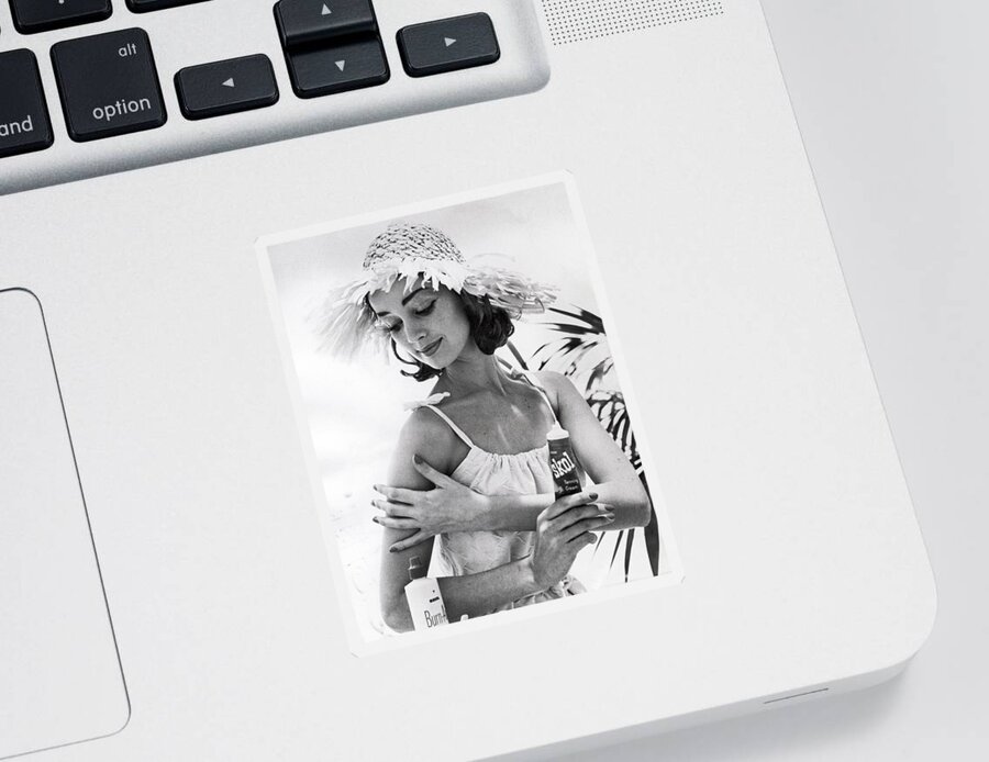  Sticker featuring the photograph Young Woman Applies Tanning Cream by Underwood Archives