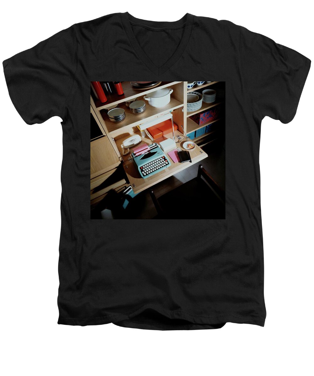 Indoors Men's V-Neck T-Shirt featuring the photograph A Cupboard With A Blue Typewriter by Ernst Beadle