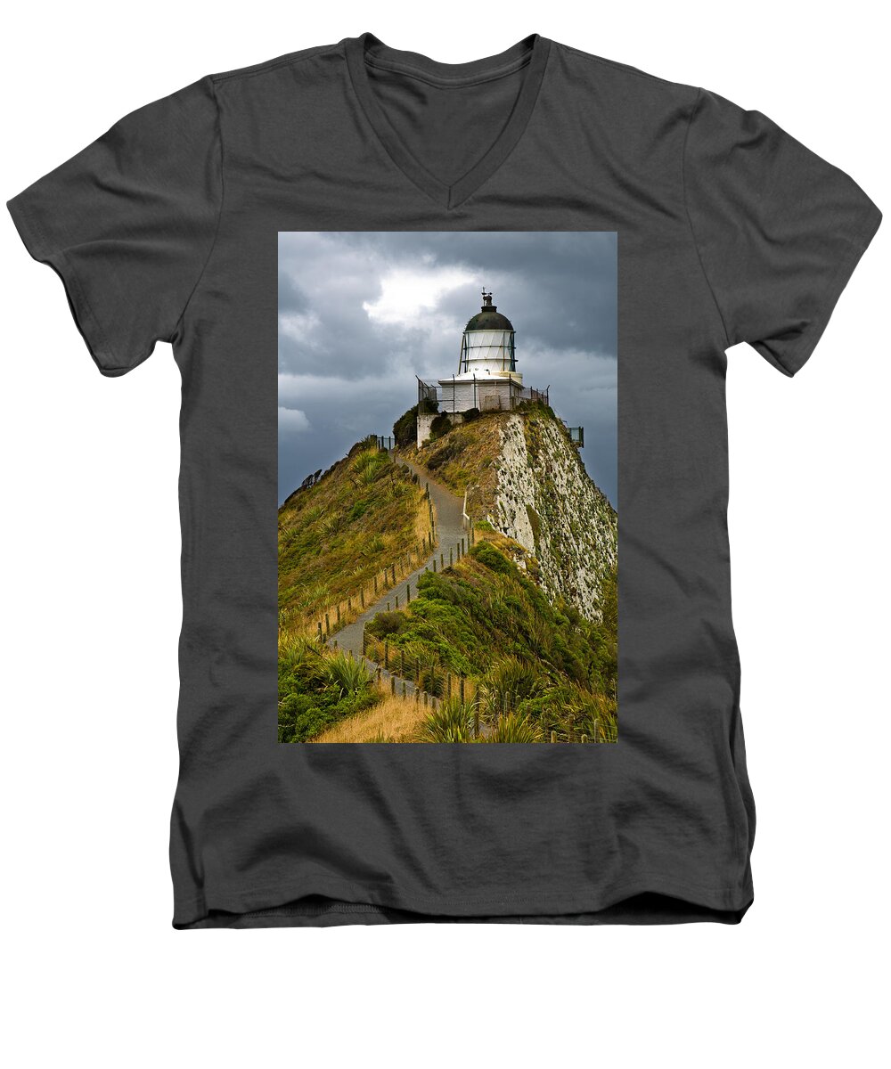Beach Men's V-Neck T-Shirt featuring the photograph Nugget Point Light House and dark clouds in the sky by U Schade