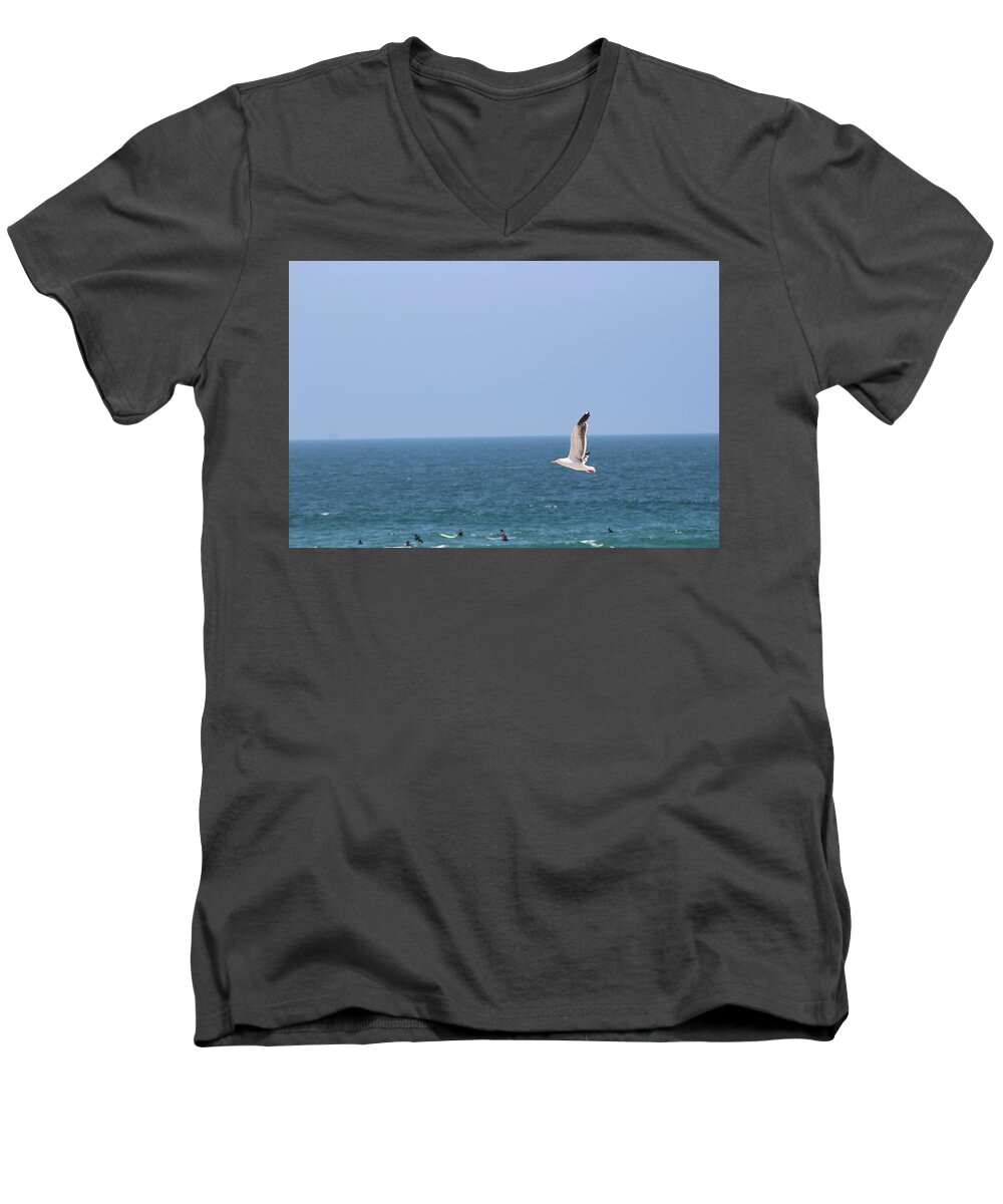 Seagull Men's V-Neck T-Shirt featuring the photograph Seagull Flying over Huntington Beach by Colleen Cornelius