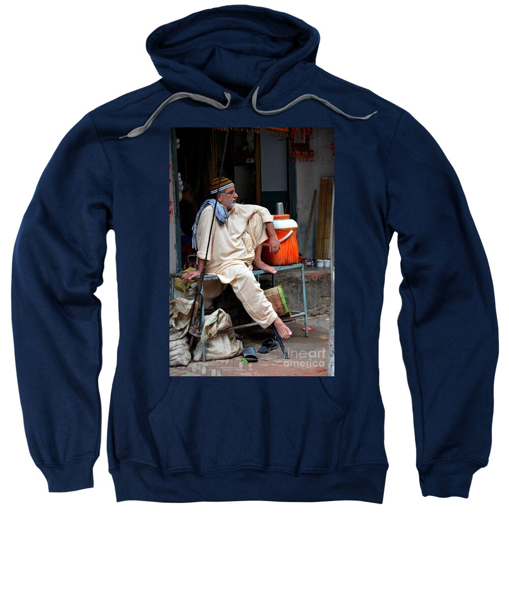 Rustic Sweatshirt featuring the photograph Man sits and relaxes in Lahore walled city Pakistan by Imran Ahmed