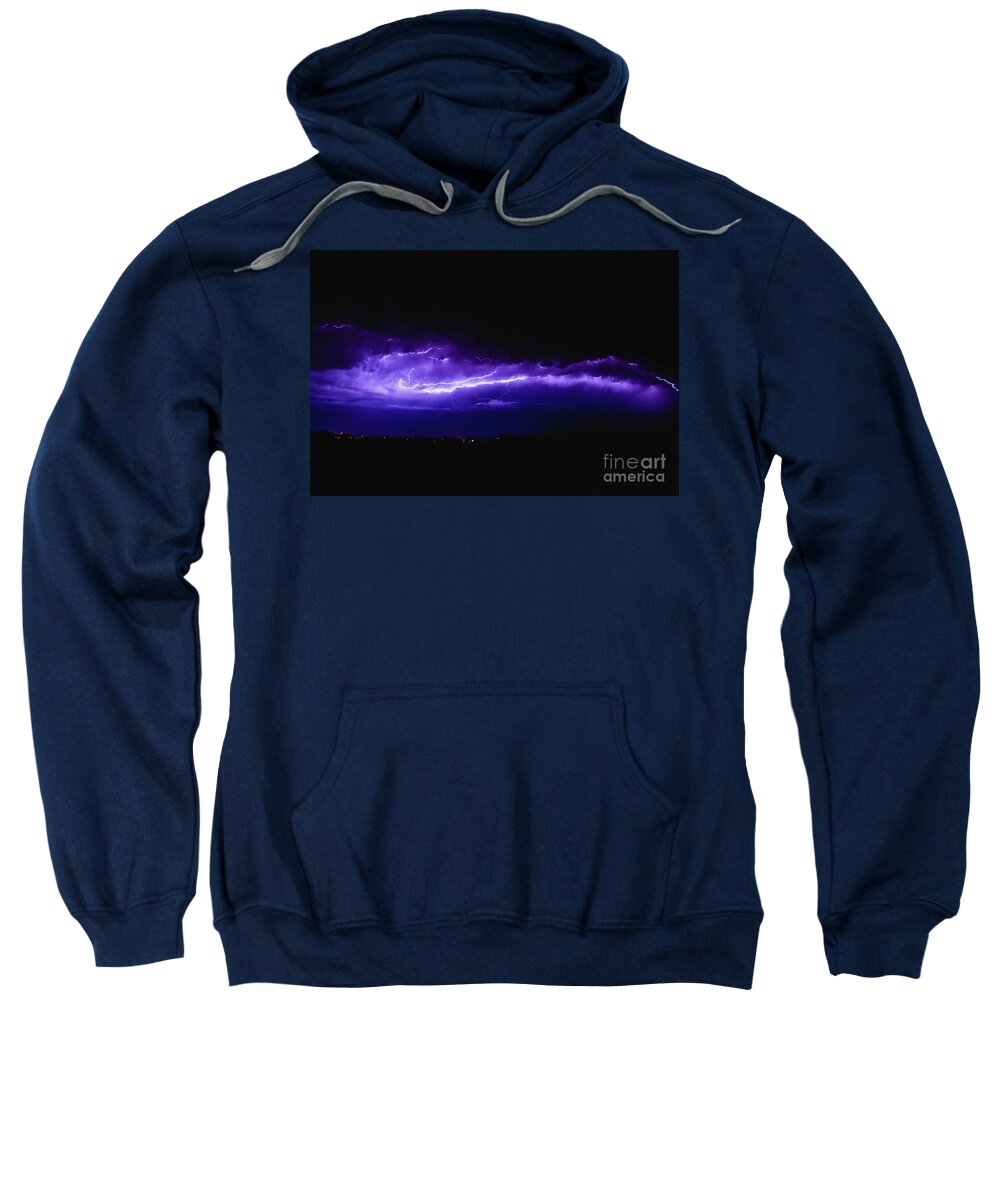Background Sweatshirt featuring the photograph Rays in a night storm with light and clouds. by Joaquin Corbalan