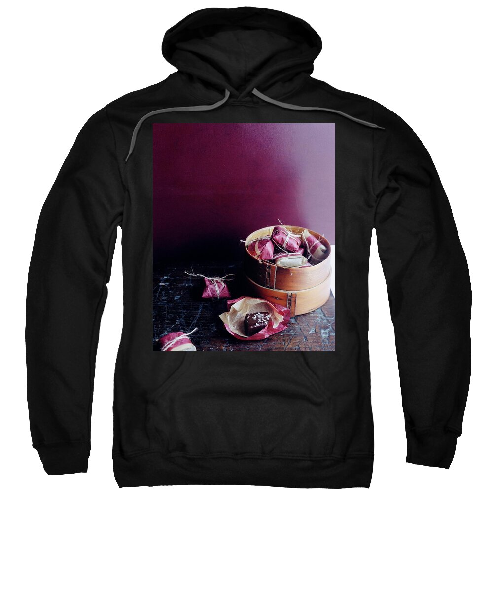 Cooking Sweatshirt featuring the photograph A Bamboo Steamer With Paper Packages by Romulo Yanes