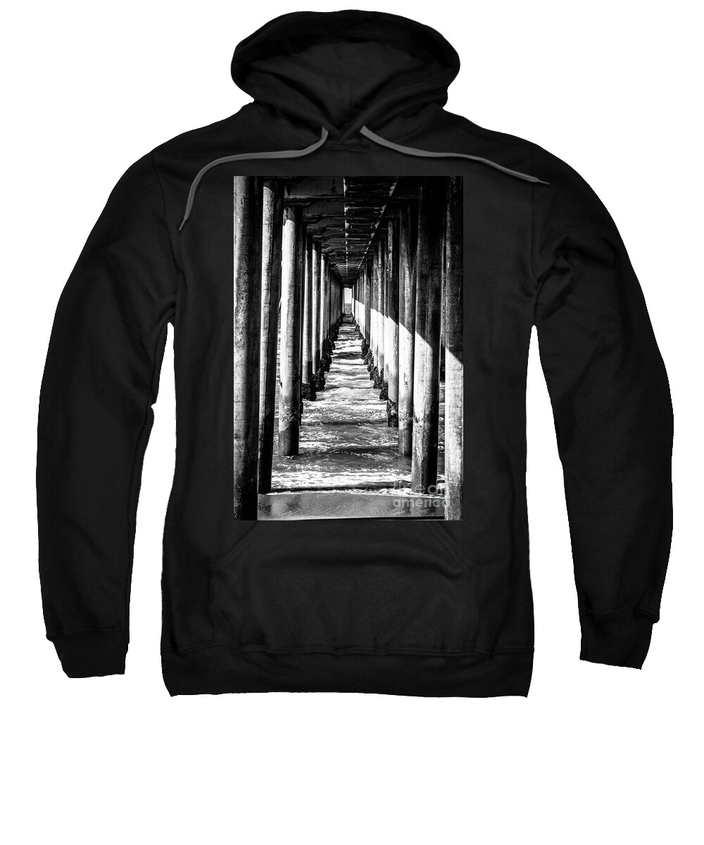 America Sweatshirt featuring the photograph Under Huntington Beach Pier Black and White Picture by Paul Velgos