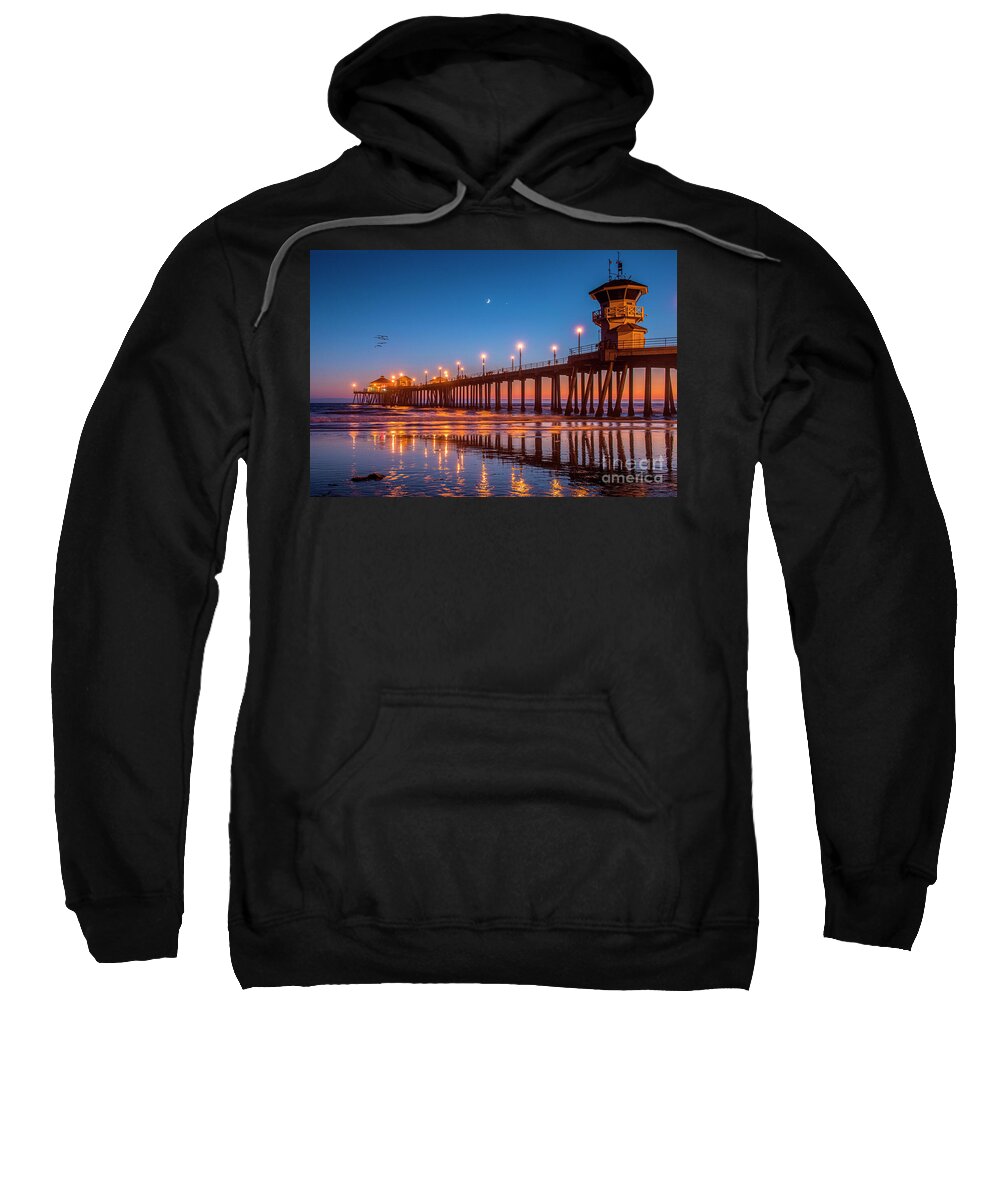 Huntington Beach Pier Lit At Night Sweatshirt featuring the photograph Huntington Beach Pier Lit at Night by David Zanzinger