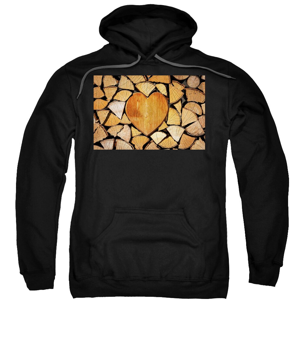 Pile Sweatshirt featuring the photograph Stack of firewood with a wooden heart by Bernhard Schaffer