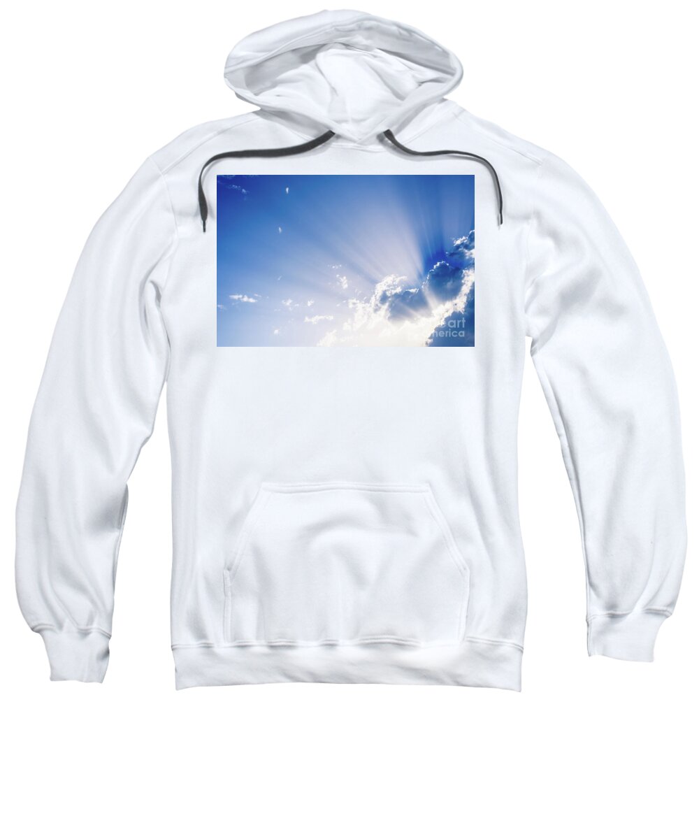 Background Sweatshirt featuring the photograph Sunbeams rising from a large cloud in intense blue sky on a summer afternoon by Joaquin Corbalan