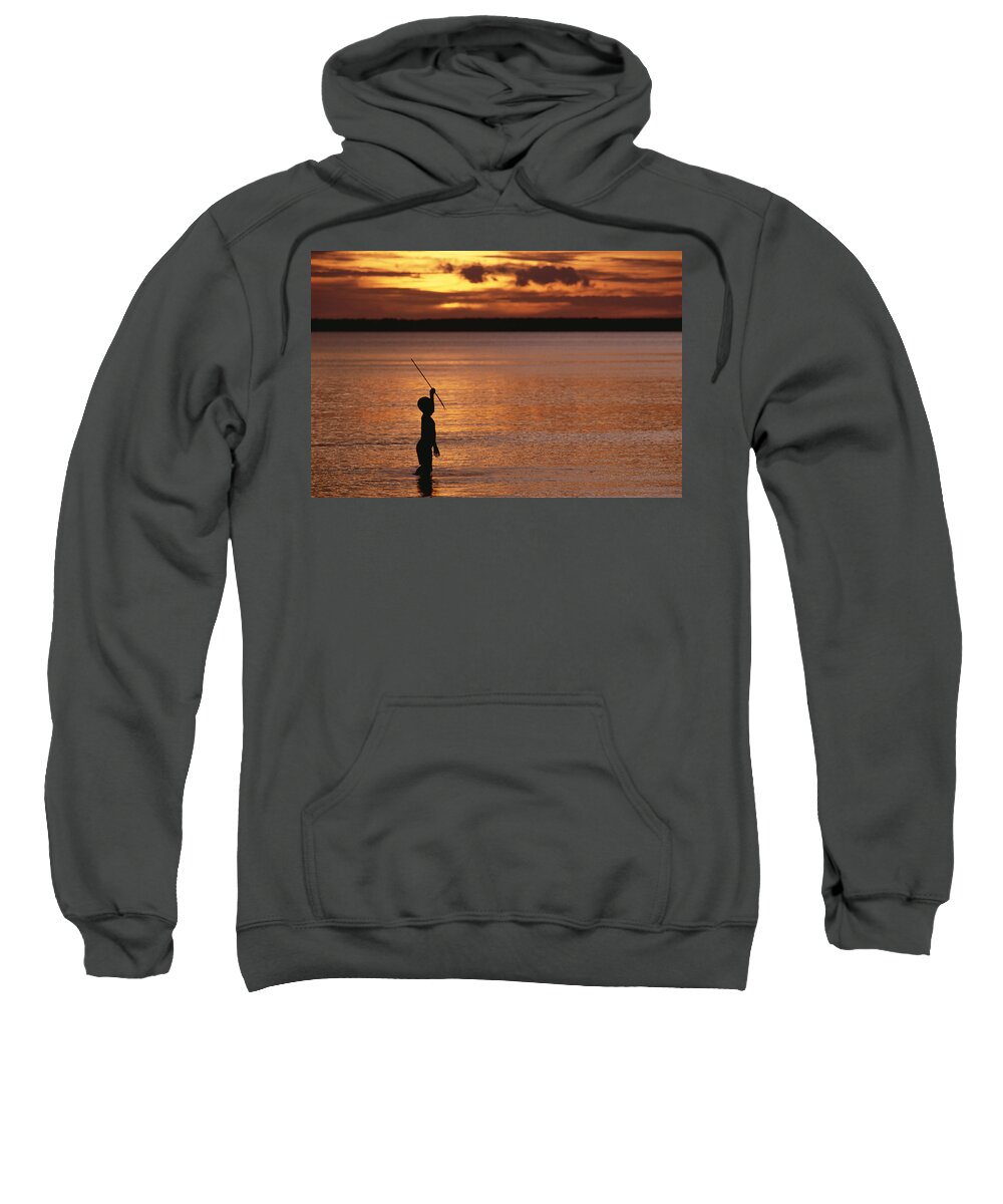 Mp Sweatshirt featuring the photograph Young Boy Spear Fishing At Sunset by Gerry Ellis