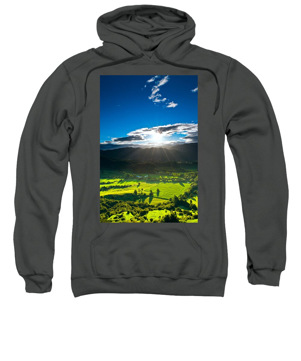 Agricultural Sweatshirt featuring the photograph Sunrays flood farmland during sunset by U Schade