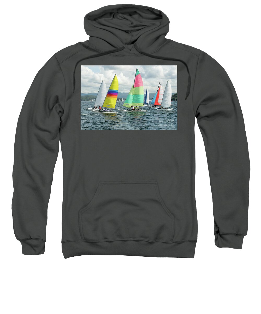 Female Sweatshirt featuring the photograph Children Sailing small sailboats with colourful sails on an inla by Geoff Childs