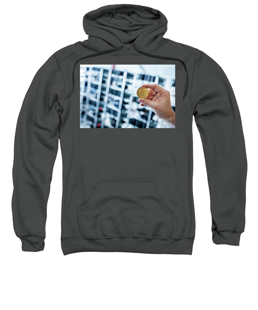 Bitcoin Sweatshirt featuring the photograph Man's hand showing bitcoin coin by Michal Bednarek