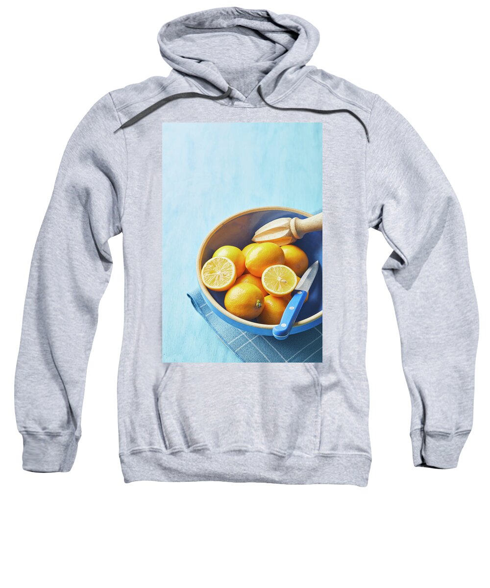Lemons Sweatshirt featuring the photograph Lemons in a blue bowl by Cuisine at Home