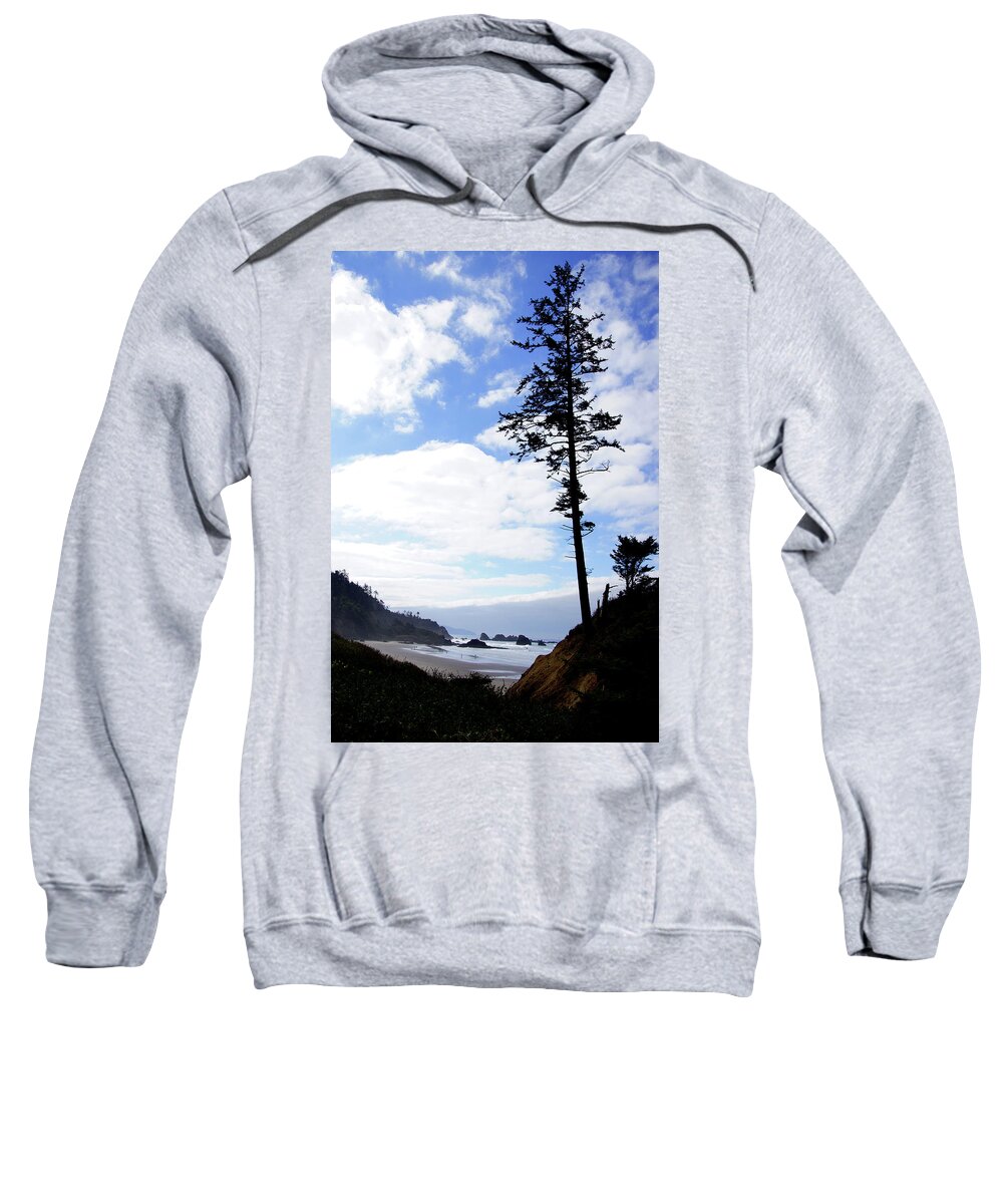 Beach Sweatshirt featuring the photograph Silhouette of large conifers on coastal headland by Steve Estvanik