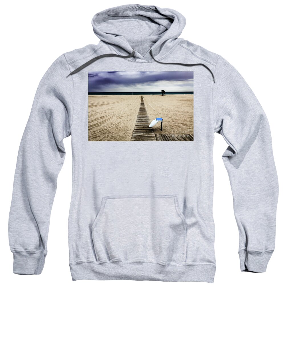 Catalonia Sweatshirt featuring the photograph Empty beach on an overcast windy day with rubbish bin #1 by Peter Noyce