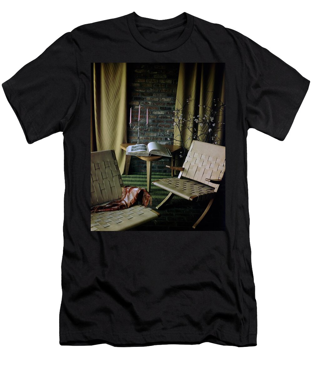 Nobody T-Shirt featuring the photograph An Armchair Beside A Table And An Old Book by Horst P. Horst