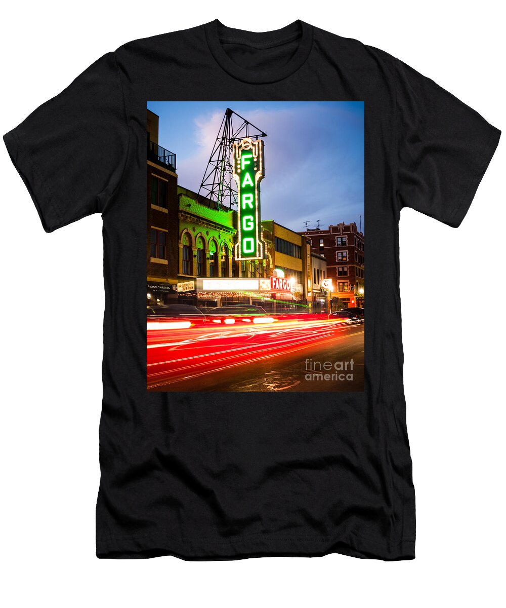 America T-Shirt featuring the photograph Fargo Theatre and Downtown Buidlings at Night by Paul Velgos