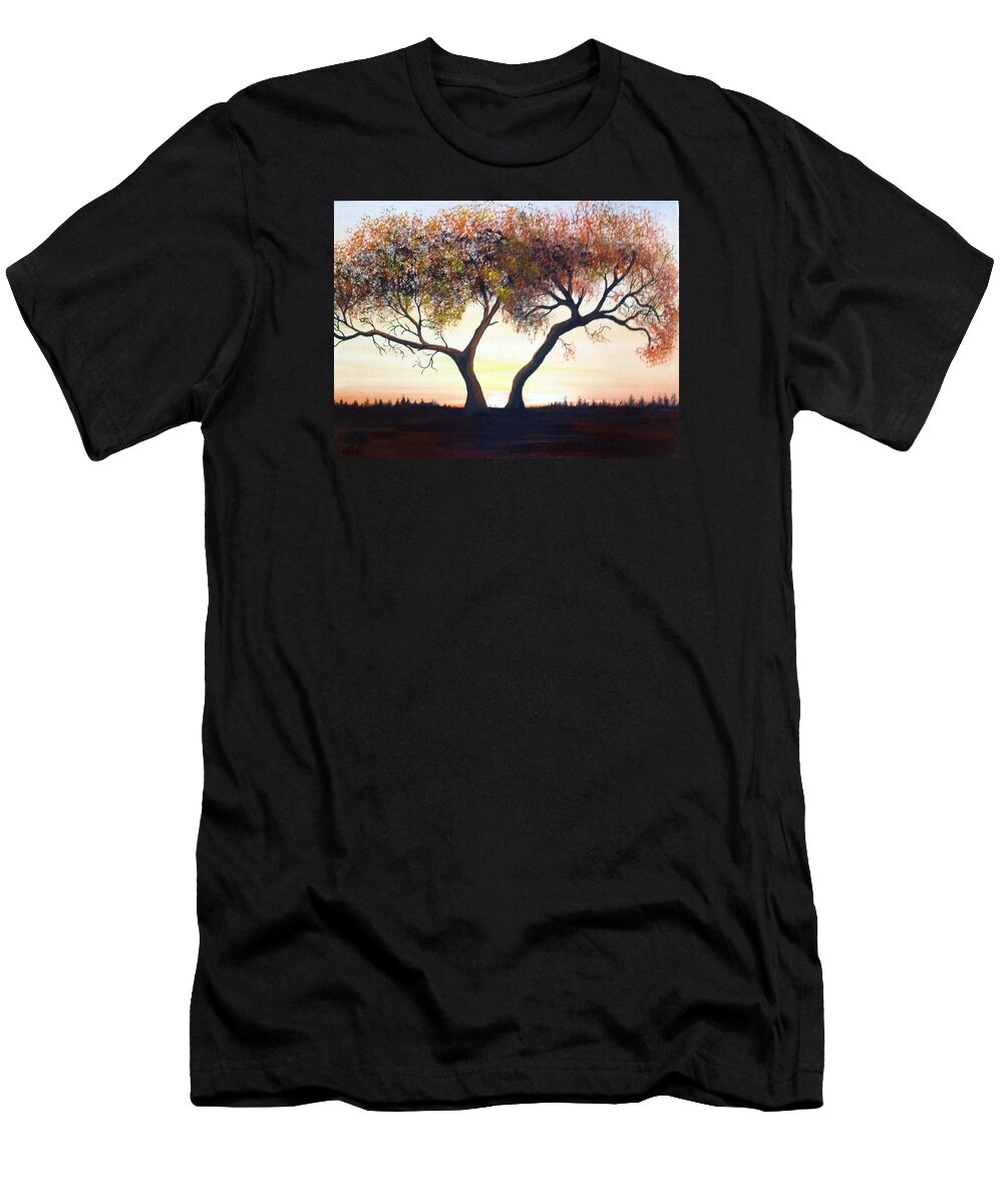 A One Hundred Year Old Tree In The Middle Of A Meadow. The Sun Is Coming Up In A Cloudless Sky With Distance Trees In The Background. The Tree Has Many Dead Branches And The Leaves Are Multiple-colored. T-Shirt featuring the painting The Eli Tree by Martin Schmidt