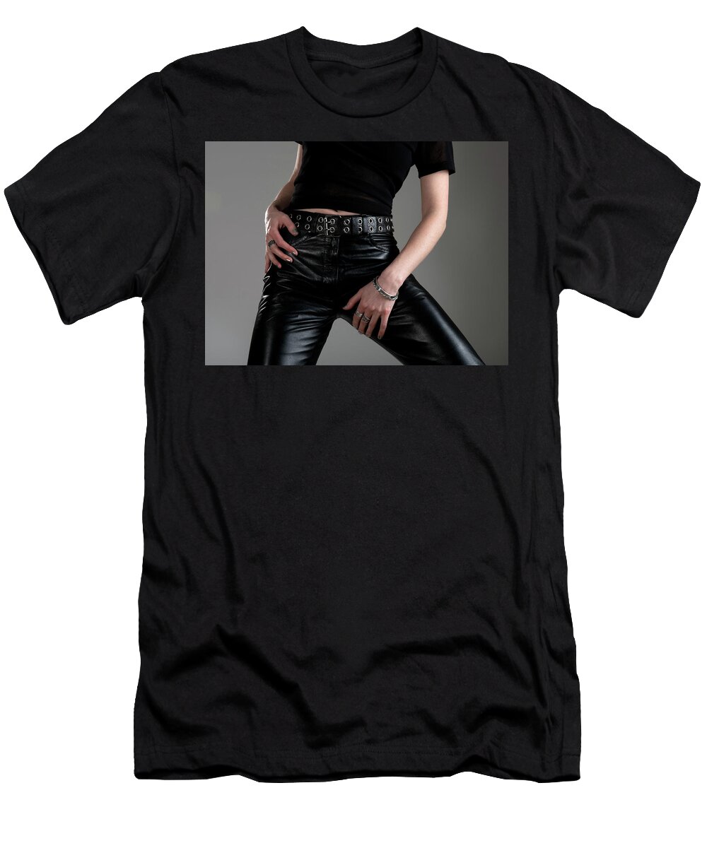 Girl T-Shirt featuring the photograph Young woman in black leather pants by GoodMood Art