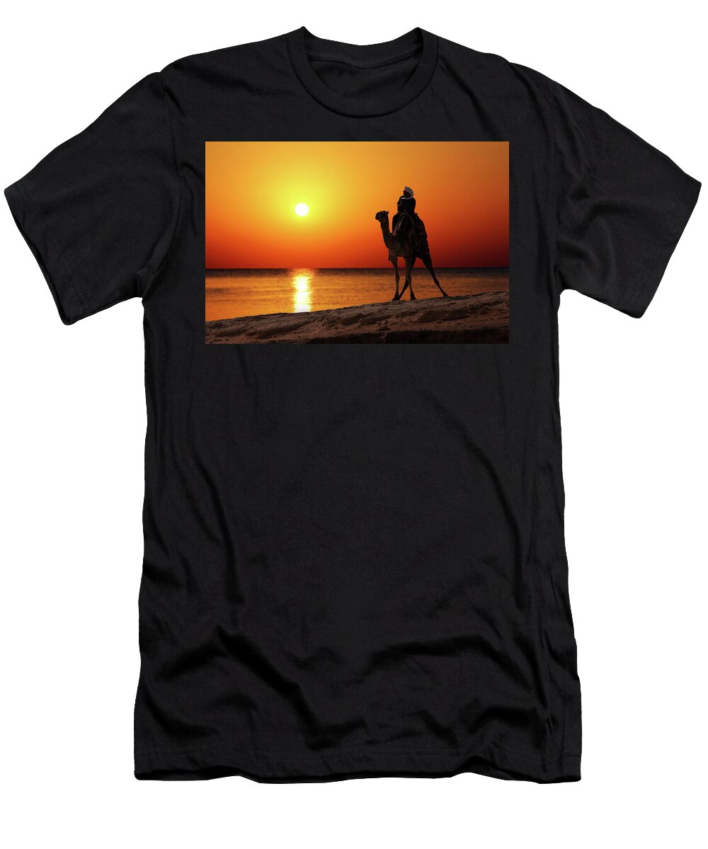 Bedouin T-Shirt featuring the photograph Bedouin On Camel Silhouette Against Sunrise #1 by Mikhail Kokhanchikov