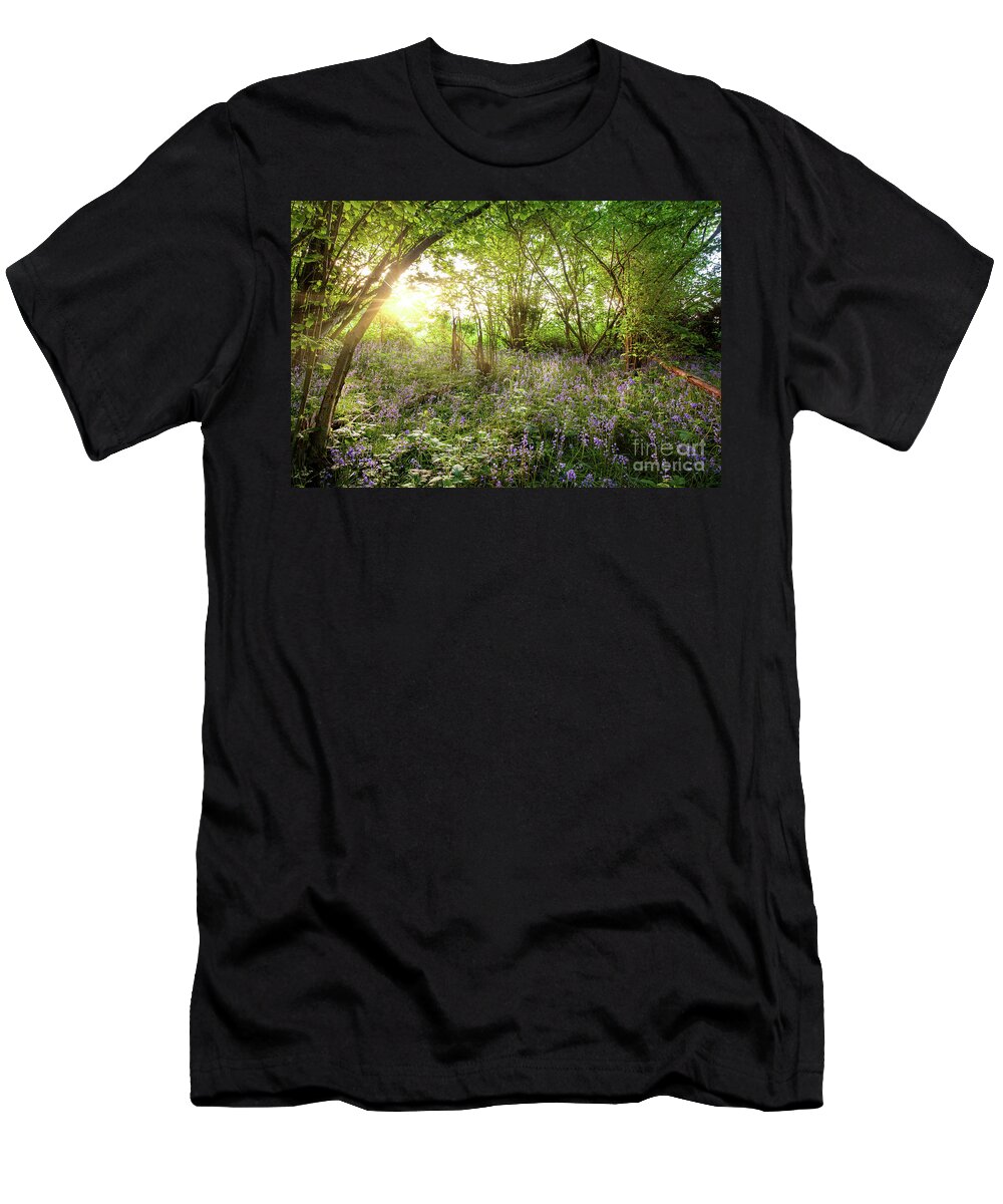 Bluebells T-Shirt featuring the photograph Sunrise streaming through bluebell wood in spring by Simon Bratt