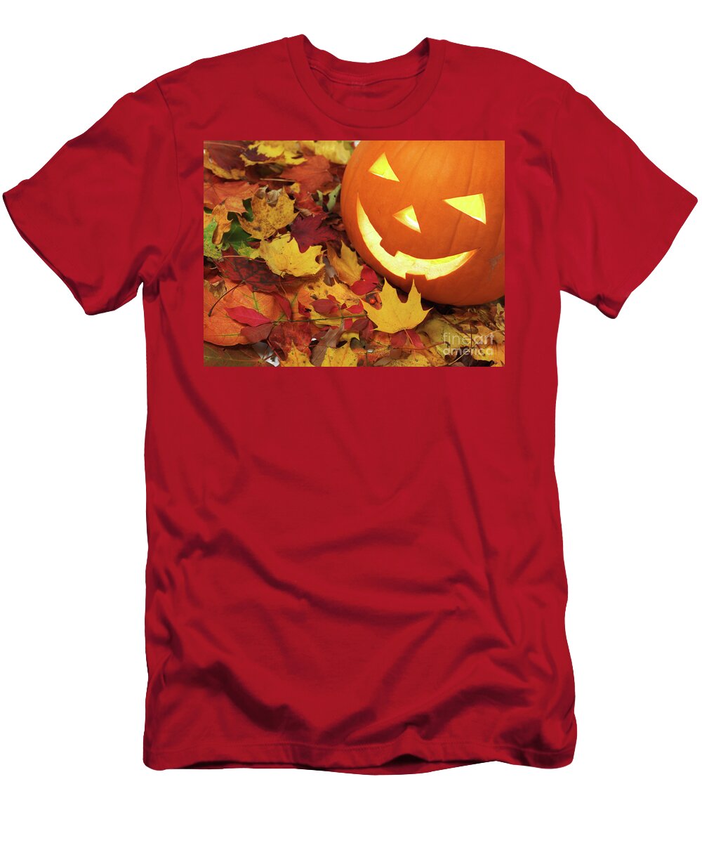 Halloween T-Shirt featuring the photograph Carved Pumpkin on Fallen Leaves #1 by Maxim Images Exquisite Prints