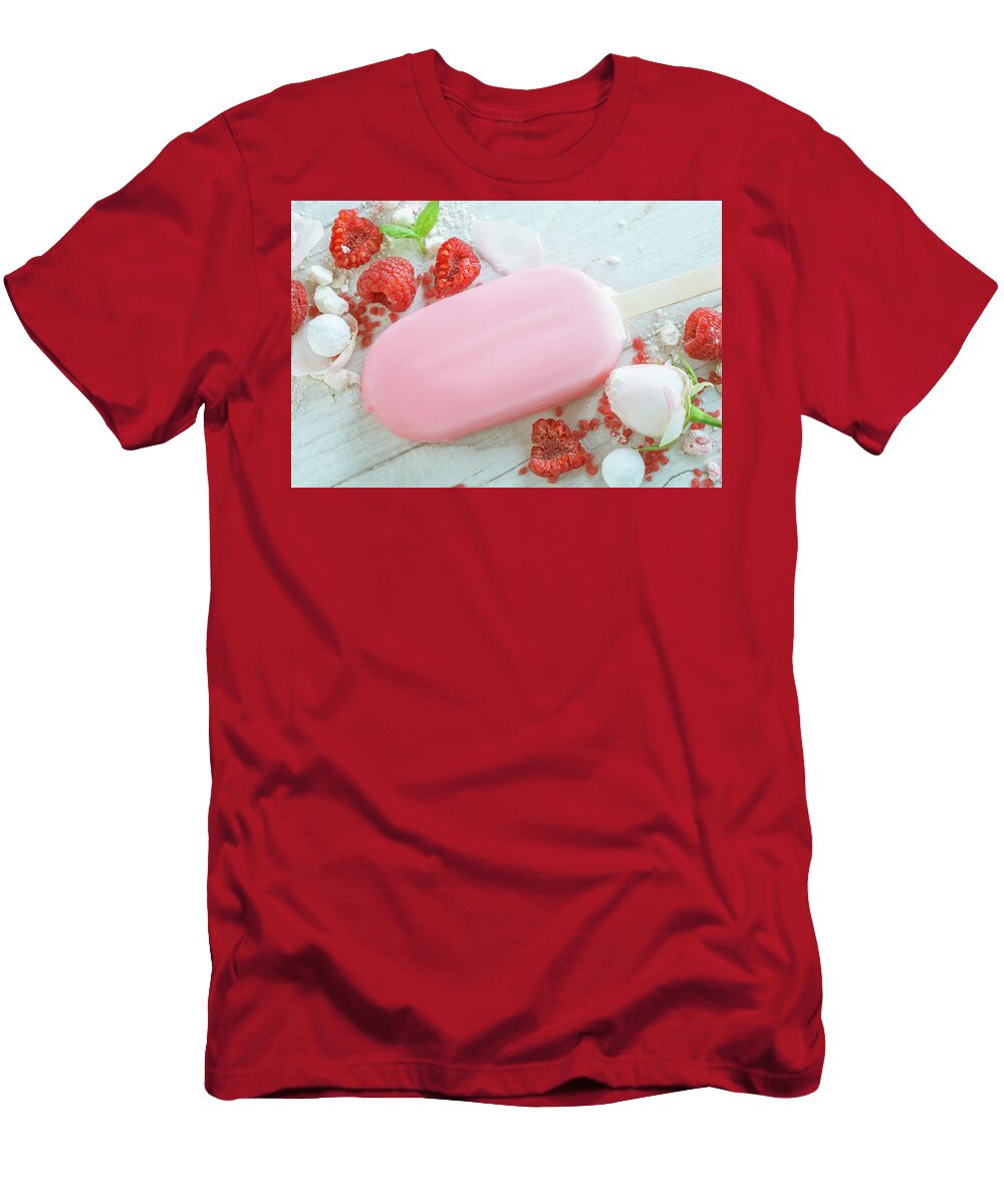 Background T-Shirt featuring the photograph Raspberries With Ice Cream In Pink Chocolate And White Petals Of Rose On Wooden Background #5 by Oleg Yermolov