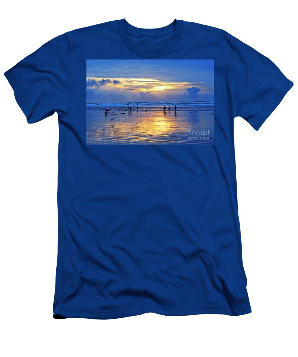 People T-Shirt featuring the photograph people recreation fun dog digging razor clams low tide ocean beach radiant blue gold sunset USA by Robert C Paulson Jr