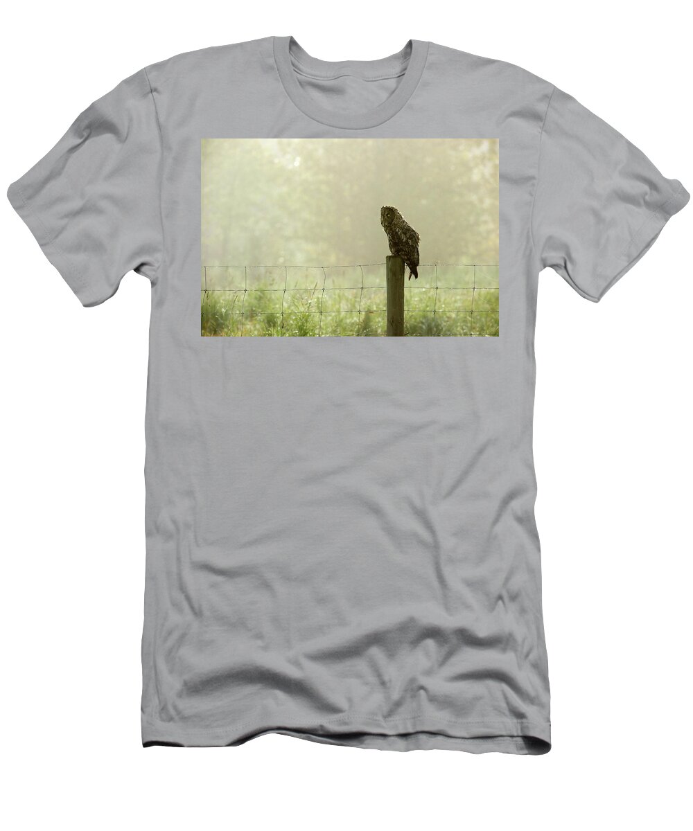 Alertness T-Shirt featuring the photograph A Great Grey Owl Sits On A Fence Post #1 by Todd Korol
